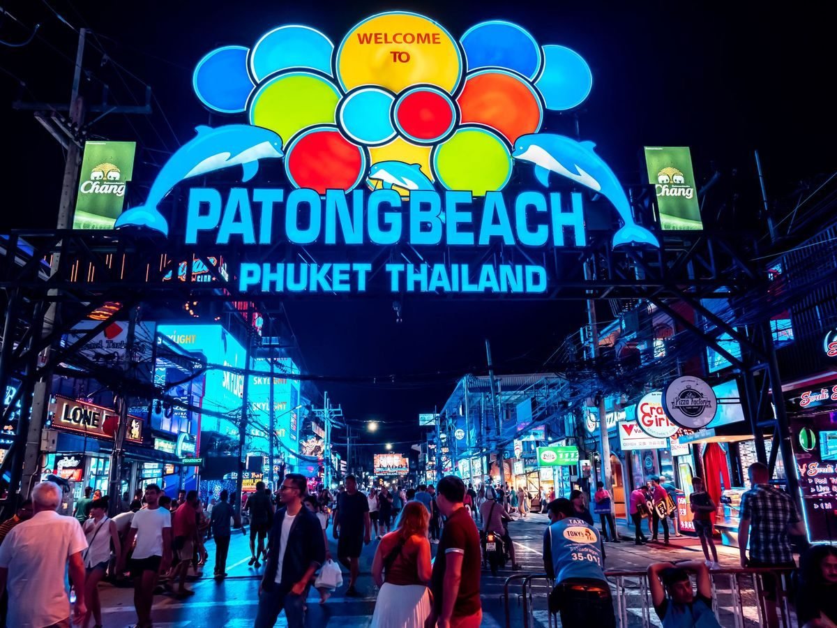 Neon 'Welcome to Patong Beach' arch at the entrance to Bangla Road at night, a 7–8 minute walk from The Way Patong Hotel