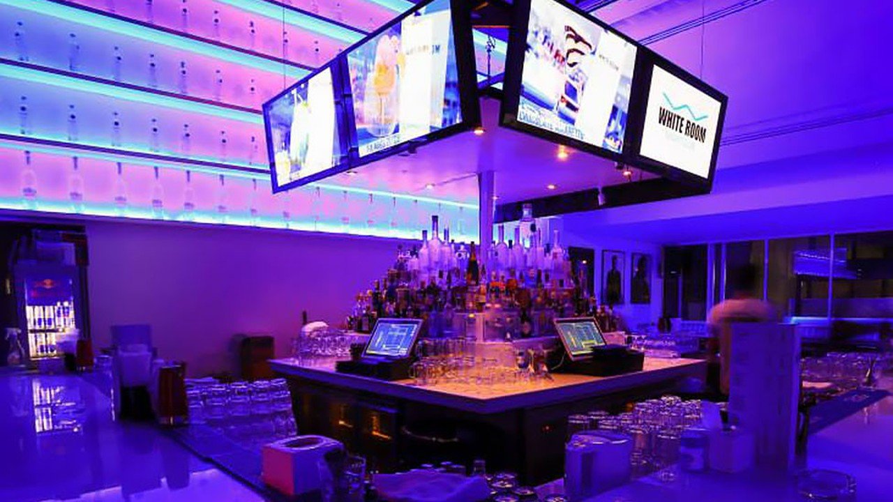 Purple-lit bar with screens at a Bangla Road venue