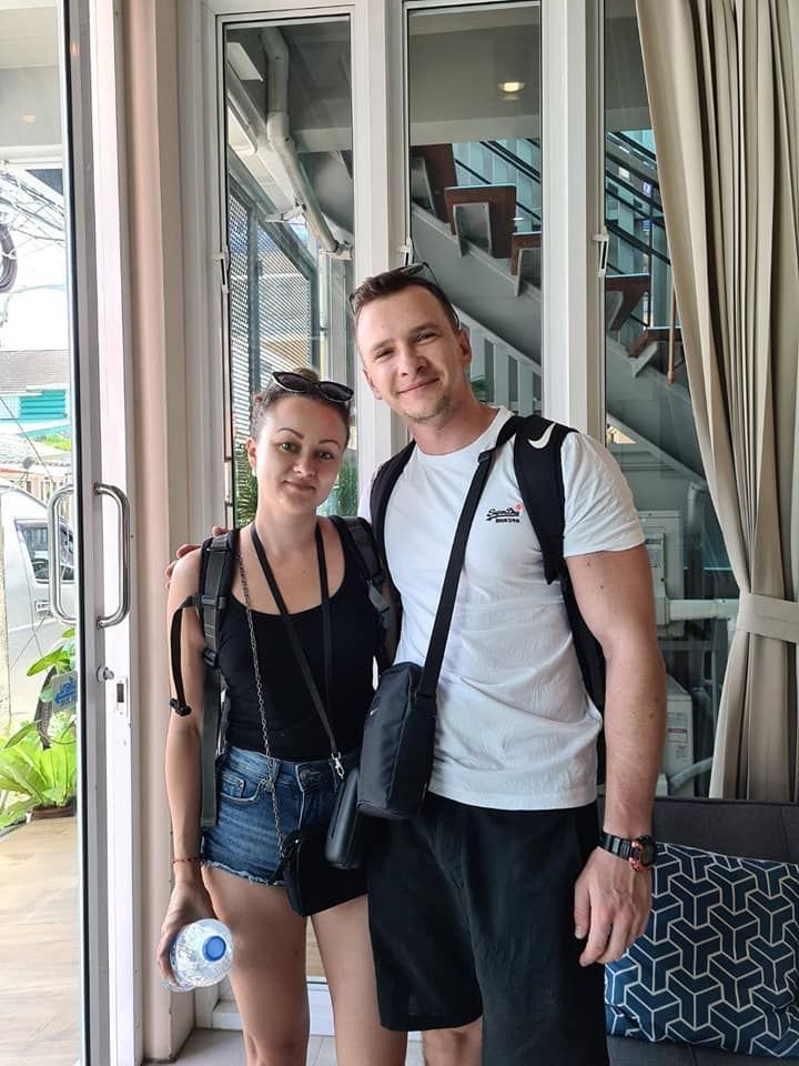 Backpacker couple at the entrance of The Way Patong Hotel