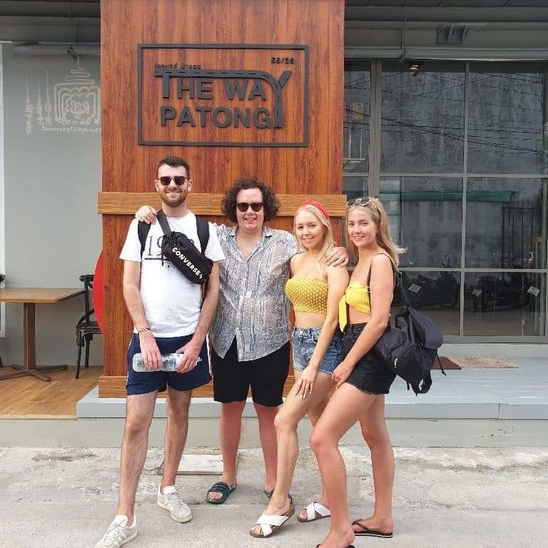 Four friends in front of The Way Patong Hotel sign