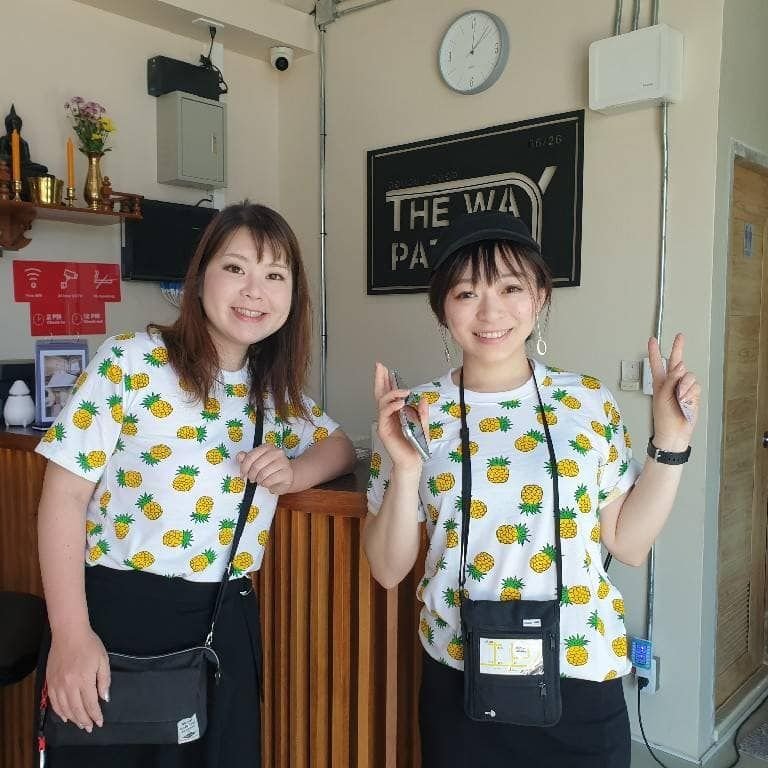 Two guests in matching pineapple shirts at The Way Patong reception
