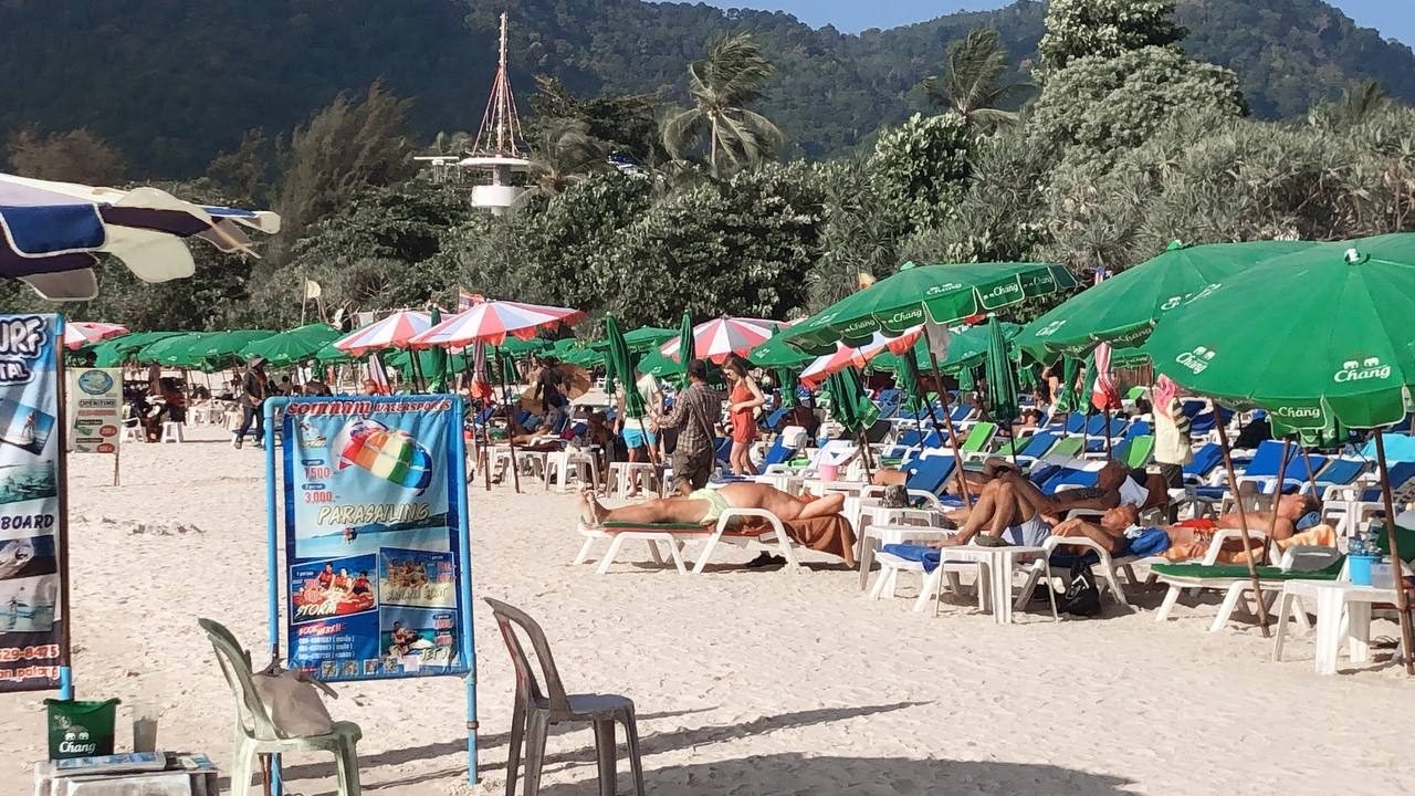 Sun umbrellas and sunbeds on Patong Beach, a 10–12 minute walk from The Way Patong Hotel