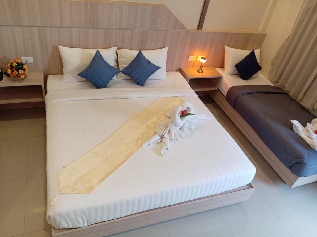 Standard Double Room at The Way Patong Hotel with a king bed and a sofa bed, made up with swan towels