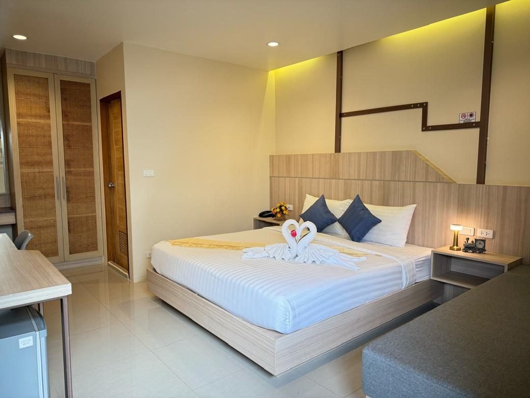Standard Double Room with king bed, wooden wardrobe and tiled floor at The Way Patong Hotel